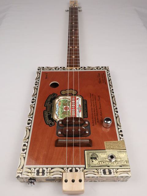Front view of a 3 string cigar box guitar made with a Queen B Fuente cigar box. This cigar box guitar is handmade by Mike Snowden of Snowden Guitars.