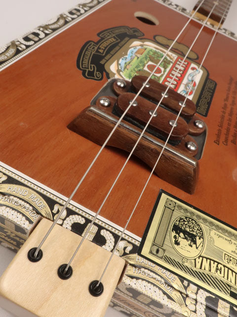 Front view of a 3 string cigar box guitar made with a Queen B Fuente cigar box. This cigar box guitar is handmade by Mike Snowden of Snowden Guitars.