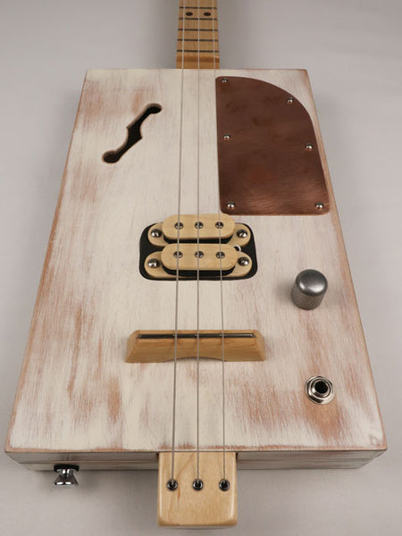 Front view of a 3 string cigar box guitar made with a humbucker pickup and copper pick guard. This cigar box guitar is handmade by Mike Snowden of Snowden Guitars.