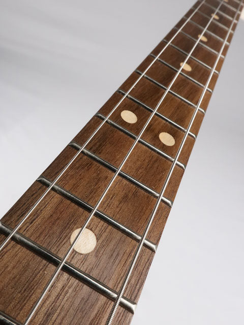 Front view of a walnut fretboard on a 3 string cigar box guitar with maple inlay. This cigar box guitar is ahndmade by Mike Snowden of Snowden guitars.