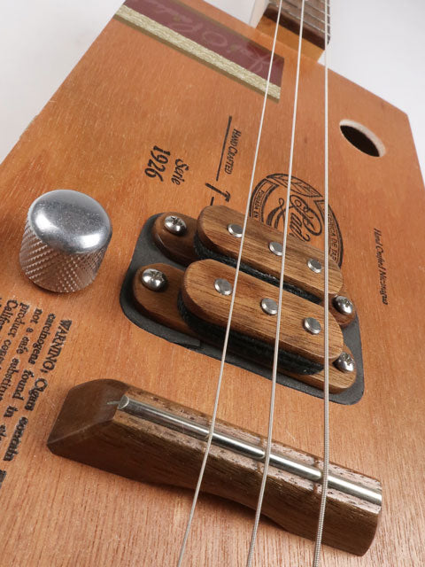 Front view of a 3 string cigar box guitar made with a Padron cigar box. This cigar box guitar is made with a walnut humbucker pickup and walnut fretboard. Handmade by Mike Snowden of Snowden guitars.