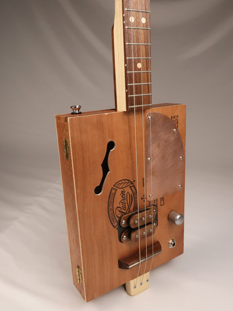 Front view of a 3 string cigar box guitar made with a Padron cigar box. Handmade by Mike Snowden of Snowden Guitars.