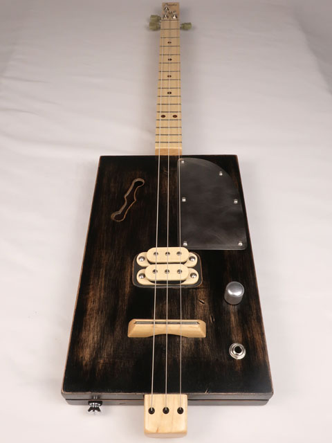 Front view of a 3 string cigar box guitar with a humbucker pickup. Handmade by Mike Snowden of Snowden Guitars.