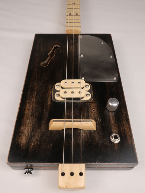 Front view of a 3 string cigar box guitar with a humbucker pickup. Handmade by Mike Snowden of Snowden Guitars.