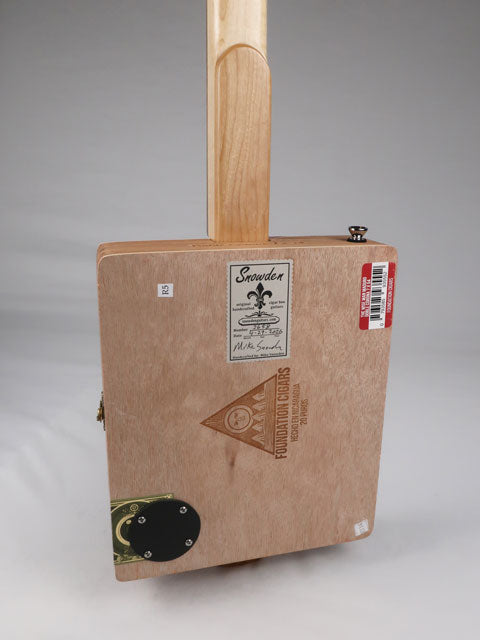 Back view of a cigar box guitar with a Snowden Guitars logo on the back. This cigar box guitar is handmade by Mike Snowden.