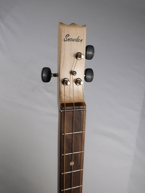 Front view of a cigar box guitar headstock with a Snowden Guitars logo on the front. Black tuning keys and a walnut fretboard. 