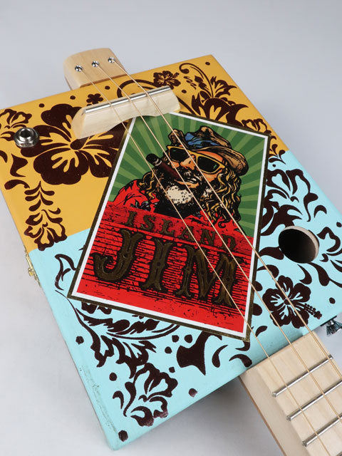 Cigar Box Guitar with Island Jim logo on the front and Hawaii feel and colors in the background. 