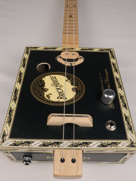 Close up front view of a  string cigar box guitar with a Brick House cigar box. Handmade by Mike Snowden of Snowden Guitars.