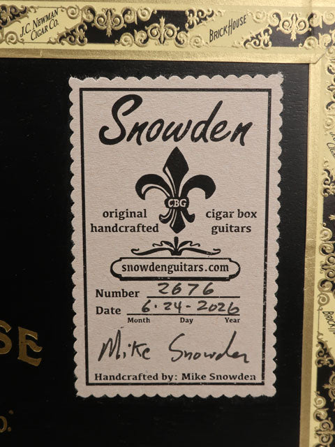 Back view of a Cigar Box Guitar label made by Snowden Guitars. This sticker shows the date and number of guitars made.