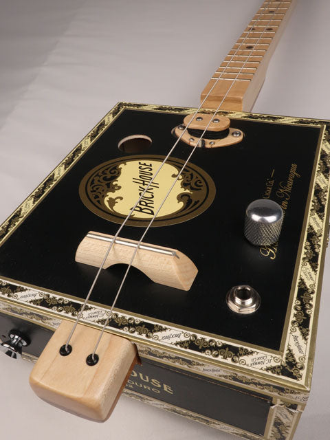 Front side view of a 2 string Cigar Box Guitar made with a Brick House cigar Box. Handmade by Mike Snowden of Snowden Guitars.