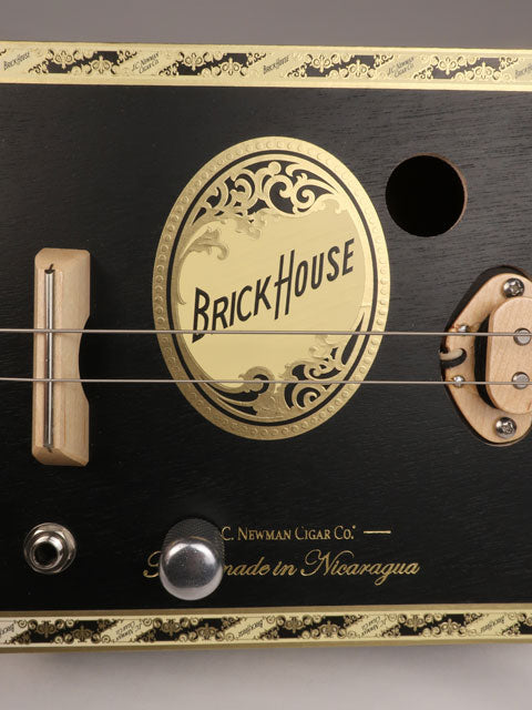 Close up front view of a 2 string Brick House Cigar Box Guitar. Handmade by Mike Snowden of Snowden Guitars.