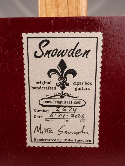 Back view of a cigar box guitar with a snowden guitars label. The label shows the number and date the cigar box guitar was made by Mike Snowden of Snowden Guitars.