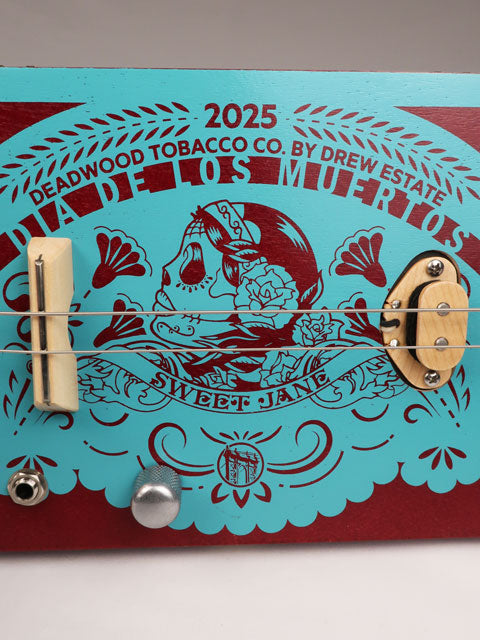Front view of a 2 string cigar box guitar made with a Sweet Jane cigar box. Handmade by Mike Snowden of Snowden Guitars.