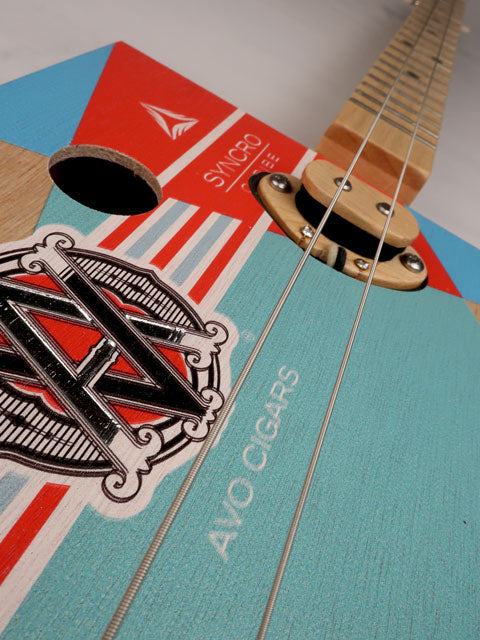 Front view of a 2 string cigar box guitar made with an AVO cigar box. Handmade by Mike Snowden of Snowden Guitars.