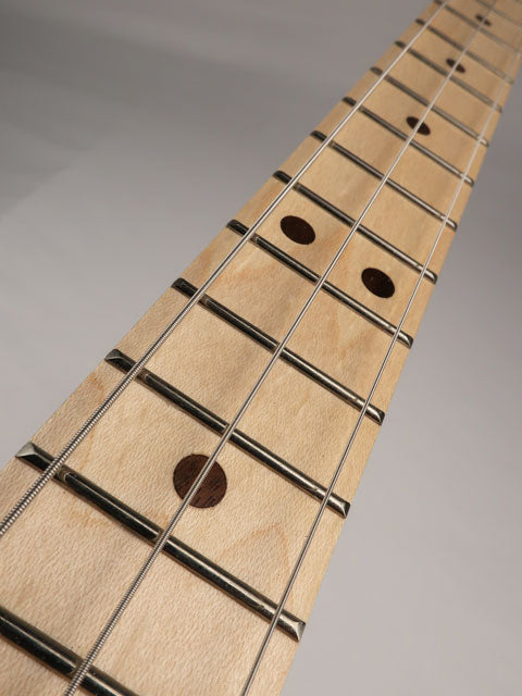 Close up view of a 3 string cigar box guitar neck made with maple fretboard and walnut inlay handmade by Mike Snowden of Snowden Guitars.