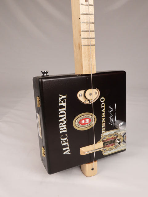Front view of a one string cigar box guitar made with a Alec Bradley cigar box. Handmade by Mike Snowden of Snowden Guitars. 