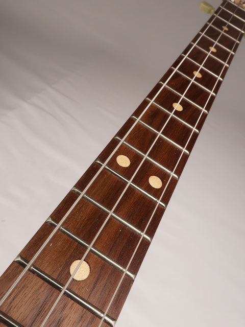 Front view of a 3 string cigar box guitar neck with walnut fret board. Handmade by Mike Snowden of Snowden Guitars.