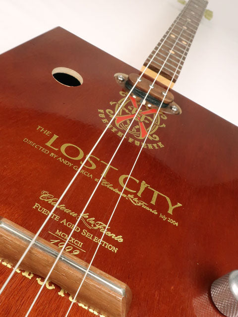 Front tilted view of a 3 string cigar box guitar made with a Lost City Cigar box. Handmade by Mike Snowden of Snowden Guitars.