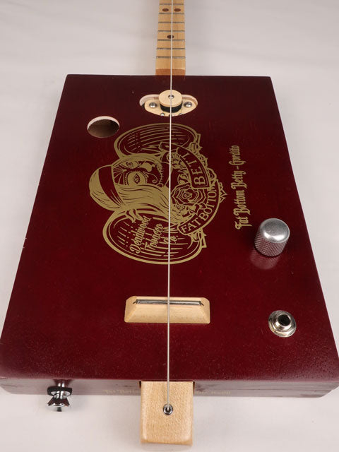 Front view of a one string diddly bow cigar box guitar made with a Fat Bottom Betty cigar box. Handmade by Mike Snowden of Snowden Guitars.