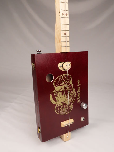 Front view of a one string diddly bow cigar box guitar made with a Fat Bottom Betty cigar box. Handmade by Mike Snowden of Snowden Guitars.