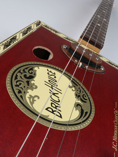 Close-up view of a cigar box guitar made from a Brick House cigar Box. The pickup is made from walnut. This cigar box guitar is handmade by Mike Snowden.