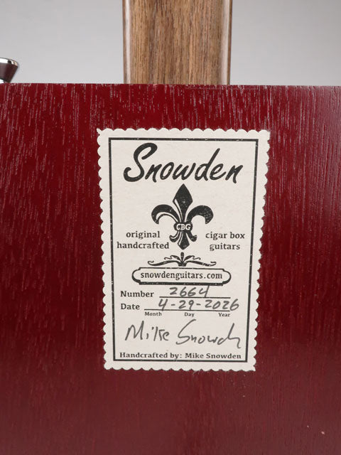 Back view of a cigar box guitar with a Snowden Guitars sticker on the back. This sticker shows the date and number made by Mike Snowden.