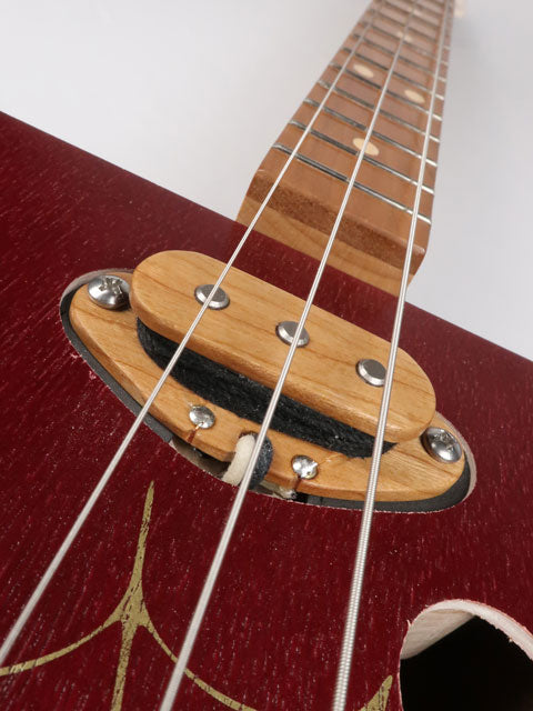 Close up view of a cigar box guitar with cherry single coil pickup. This cigar box guitar is handmade by Mike Snowden of Snowden guitars.