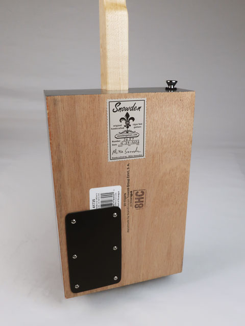 Back view of a cigar box guitar with a Snowden Guitars logo on the back. You can also see the strap holder button.