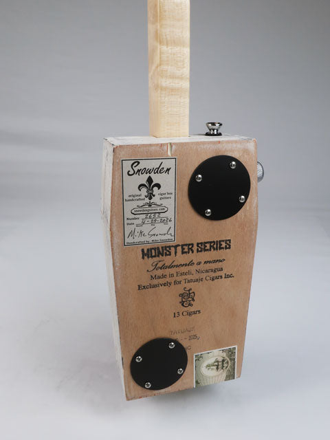 Back view of a cigar box guitar in the shape of a coffin handmade by Mike Snowden.
