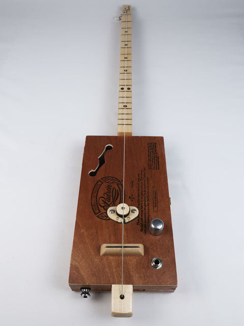 Front view of a one string diddly bow cigar box guitar with a maple single coil pickup and a maple neck and frets. This cigar box  has a f hole sound hole and is handmade by Mike Snowden.