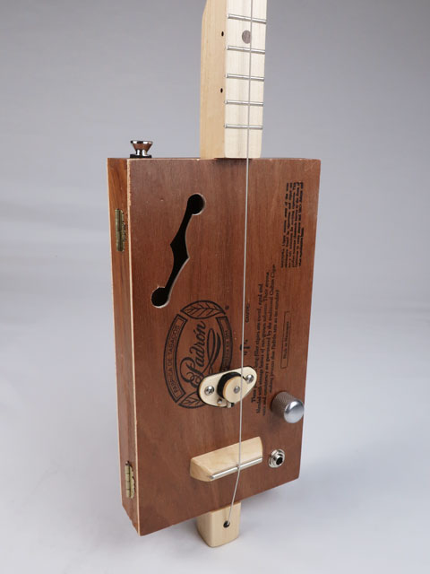 Tiled front view of a one string diddly bow cigar box guitar with a maple single coil pickup and a maple neck and frets. This cigar box guitar is handmade by Mike Snowden.