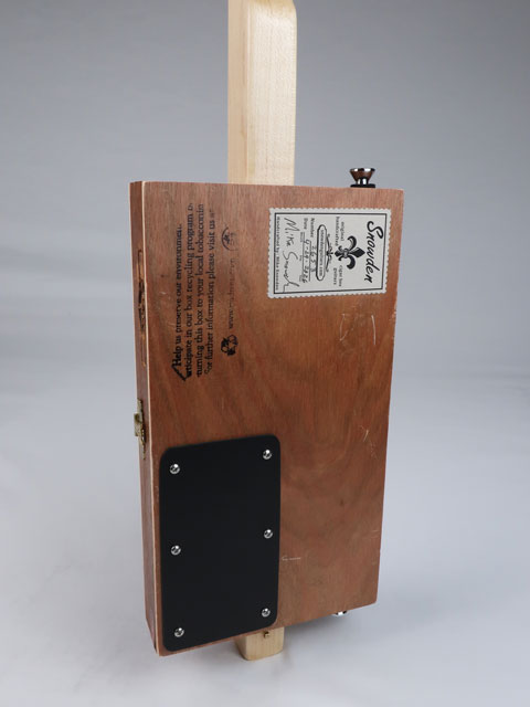 Back view of a cigar box guitar made by Mike Snowden. This cigar box guitar has a maple neck. 