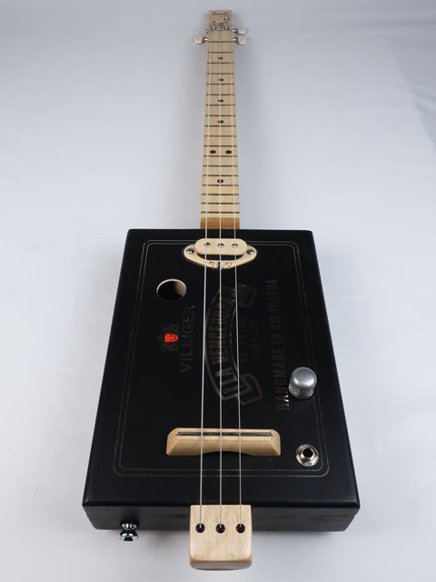 Front view of a 3 string cigar box guitar with a maple single coil pickup. Villigaer La Vencedora logo printed in silver on a black cigar box. This cigar box guitar is handmade by Mike Snowden.