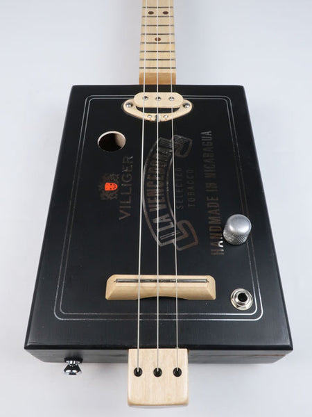 Front view of a 3 string cigar box guitar with a maple single coil pickup. Villigaer La Vencedora logo printed in silver on a black cigar box. This cigar box guitar is handmade by Mike Snowden.