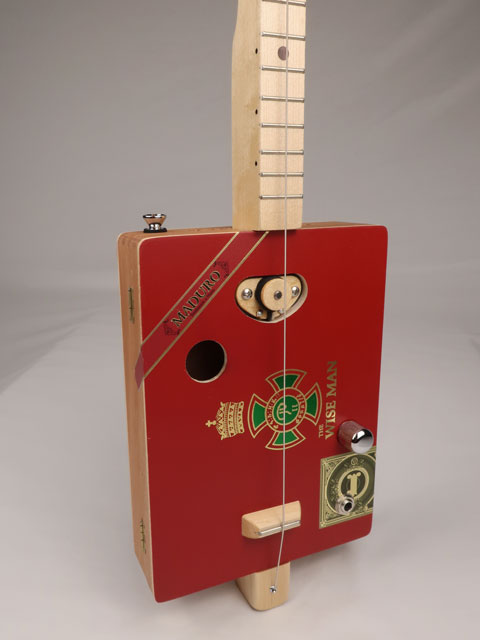 Front view of a one String cigar box guitar diddly bow cbg handmade by Mike Snowden of Snowden Guitars. This cigar box guitar is made with a wise man cigar box.