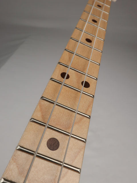 Tilted view of a 2 string cigar box guitar with a maple neck and fretboard. Handmade by Mike Snowden of Snowden Guitars.