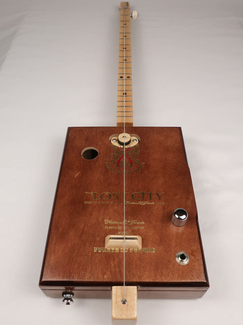 Front view of a one String diddly bow cigar box guitar CBG handmade by Mike Snowden of Snowden Guitars. This cigar box guitar is handmade with a Lost City cigar box.