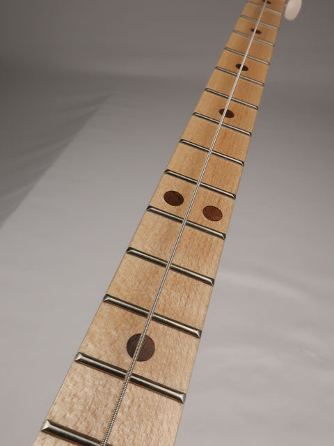 Front view of a cigar box guitar neck with a maple fretboard with walnut inlay.