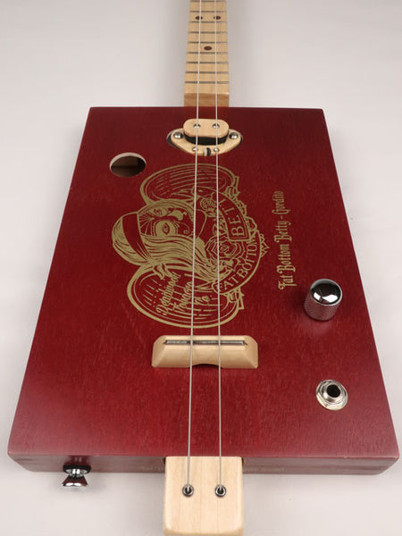 Front view of a cigar box guitar made with a Fat Betty cigar box This cigar box guitar is handmade by Mike Snowden of Snowden Guitars.