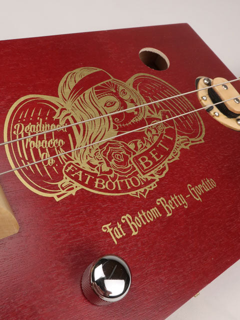Front view of a cigar box guitar made with a Fat Betty cigar box This cigar box guitar is handmade by Mike Snowden of Snowden Guitars.