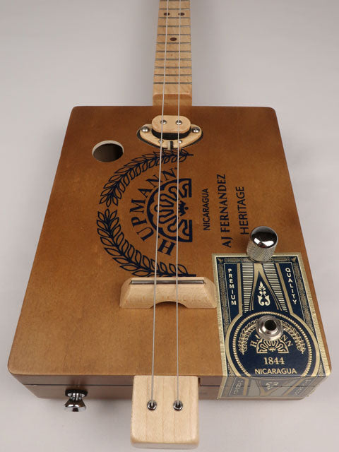 Front view of a 2 string cigar box guitar cbg made with a H. Upmann cigar box. This cigar box guitar was handmade by Mike Snowden of Snowden Guitars.