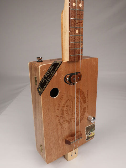 Front view of a cigar box guitar with a Jaime Garcia cigar box. This cigar box guitar is handmade by Mike Snowden of Snowden Guitars.