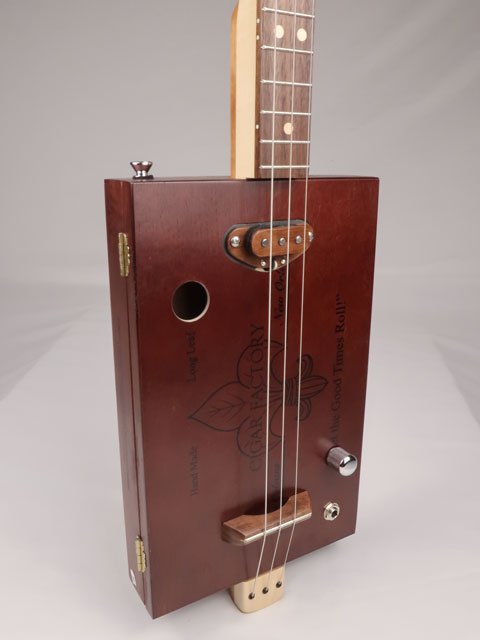 Front view of a 3 string cigar box guitar made with a New Orleans cigar factory cigar box. Handmade by Mike Snowden of Snowden Guitars.