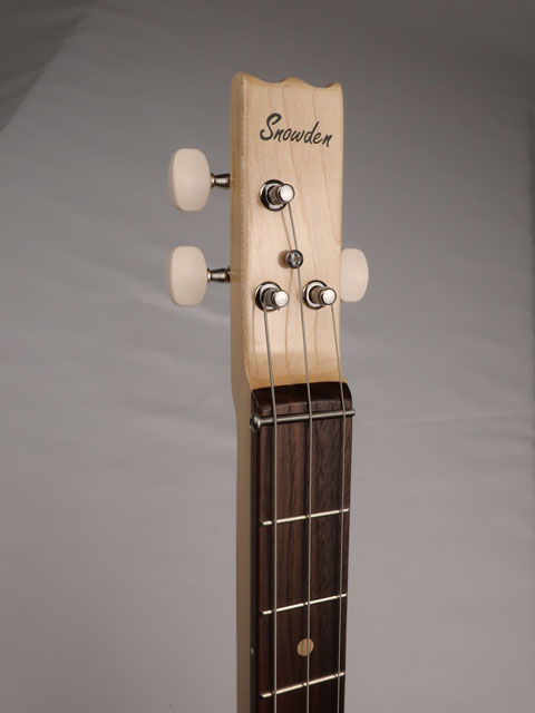 Front view of a 3 string cigar box guitar head stock with a Snowden Guitars logo on the front.