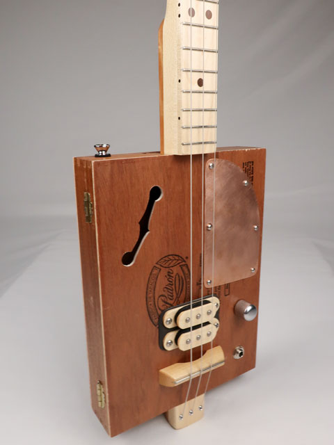 Front view of a 3 string cigar box guitar made with a Padron cigar box. Handmade by Mike Snowden of Snowden Guitars.