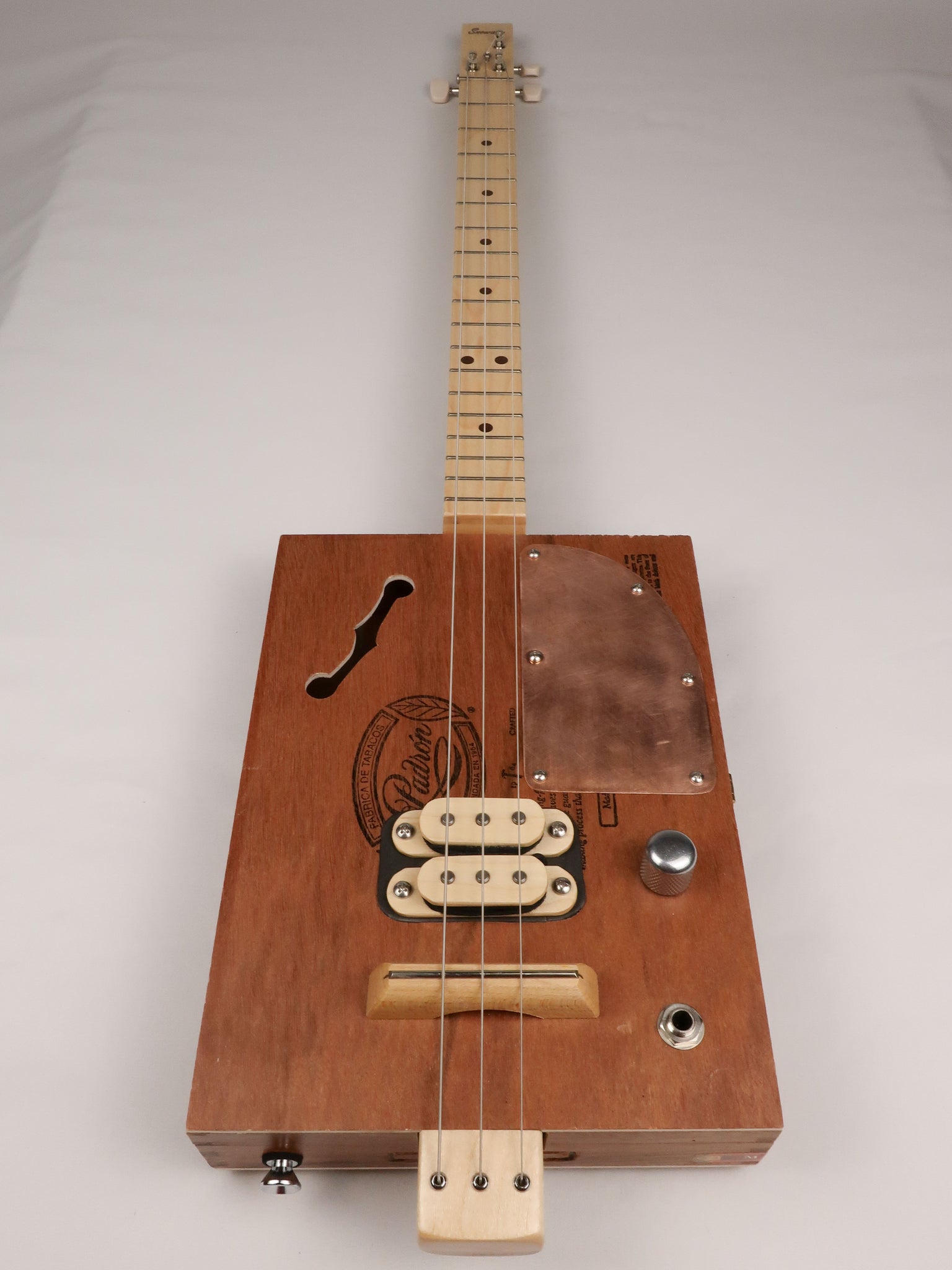 Front view of a 3 string cigar box guitar made with a Padron cigar box. Handmade by Mike Snowden of Snowden Guitars.